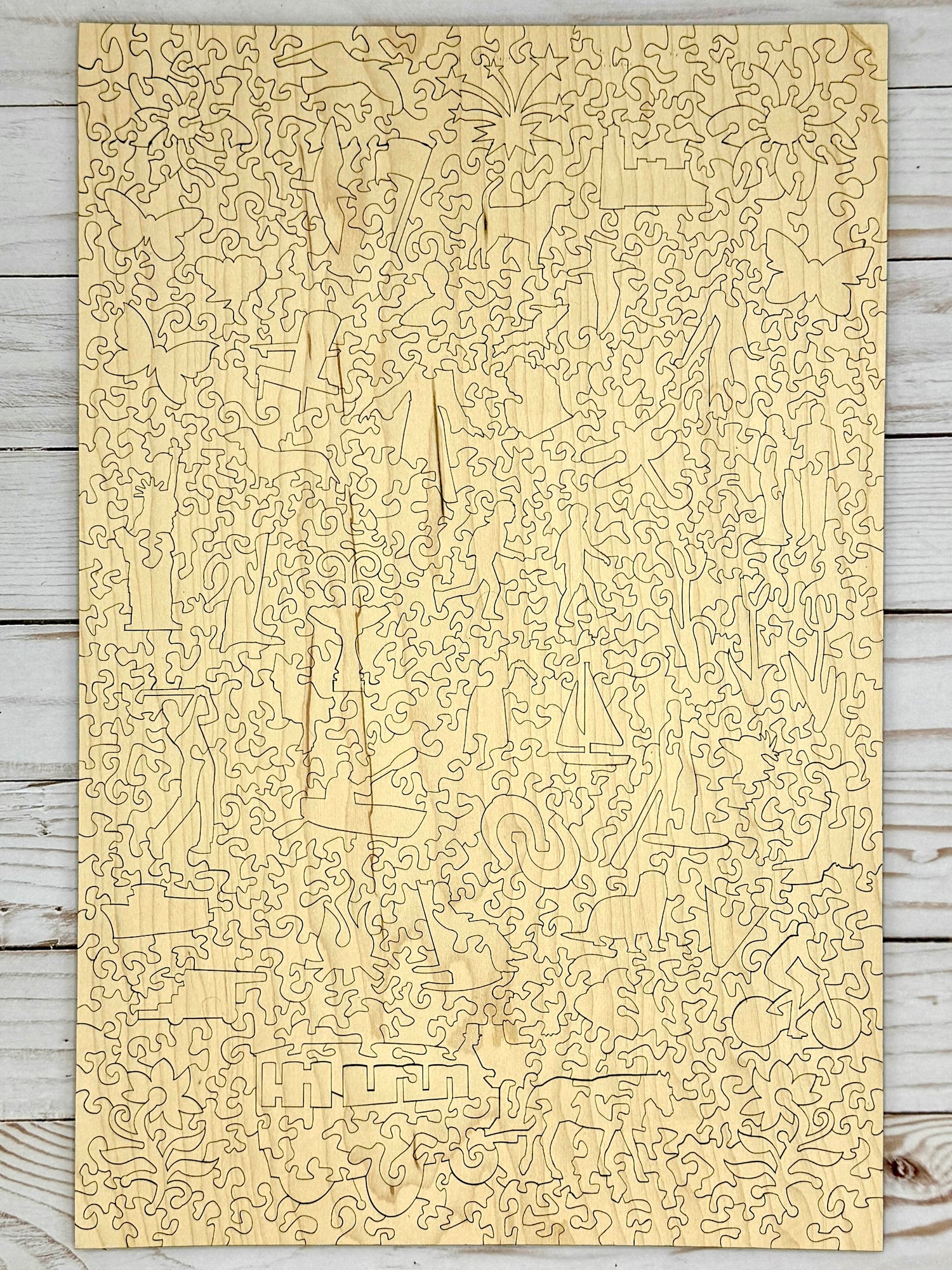 The back side of a fully assembled wooden jigsaw puzzle showing the cut design pattern.