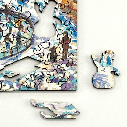 Close up of detailed wooden whimsy pieces, including snowman and sled, from the Downtown Ice Skating ice skating jigsaw puzzle.
