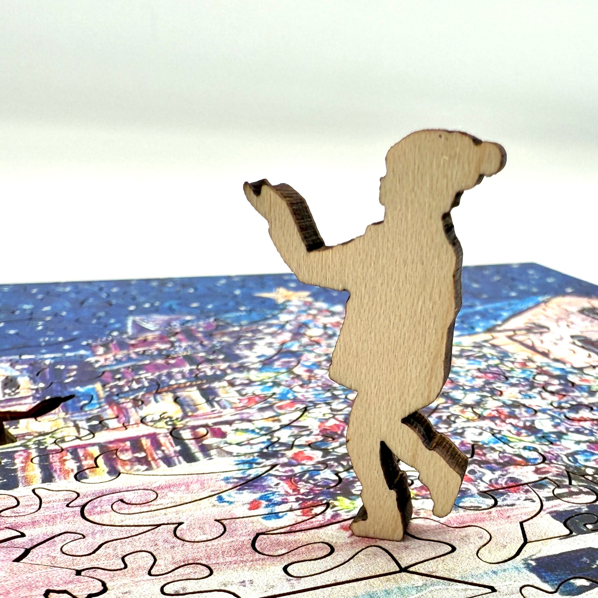 Close up view of a wooden figure piece from the Mackinac Christmas Tree holiday puzzle.