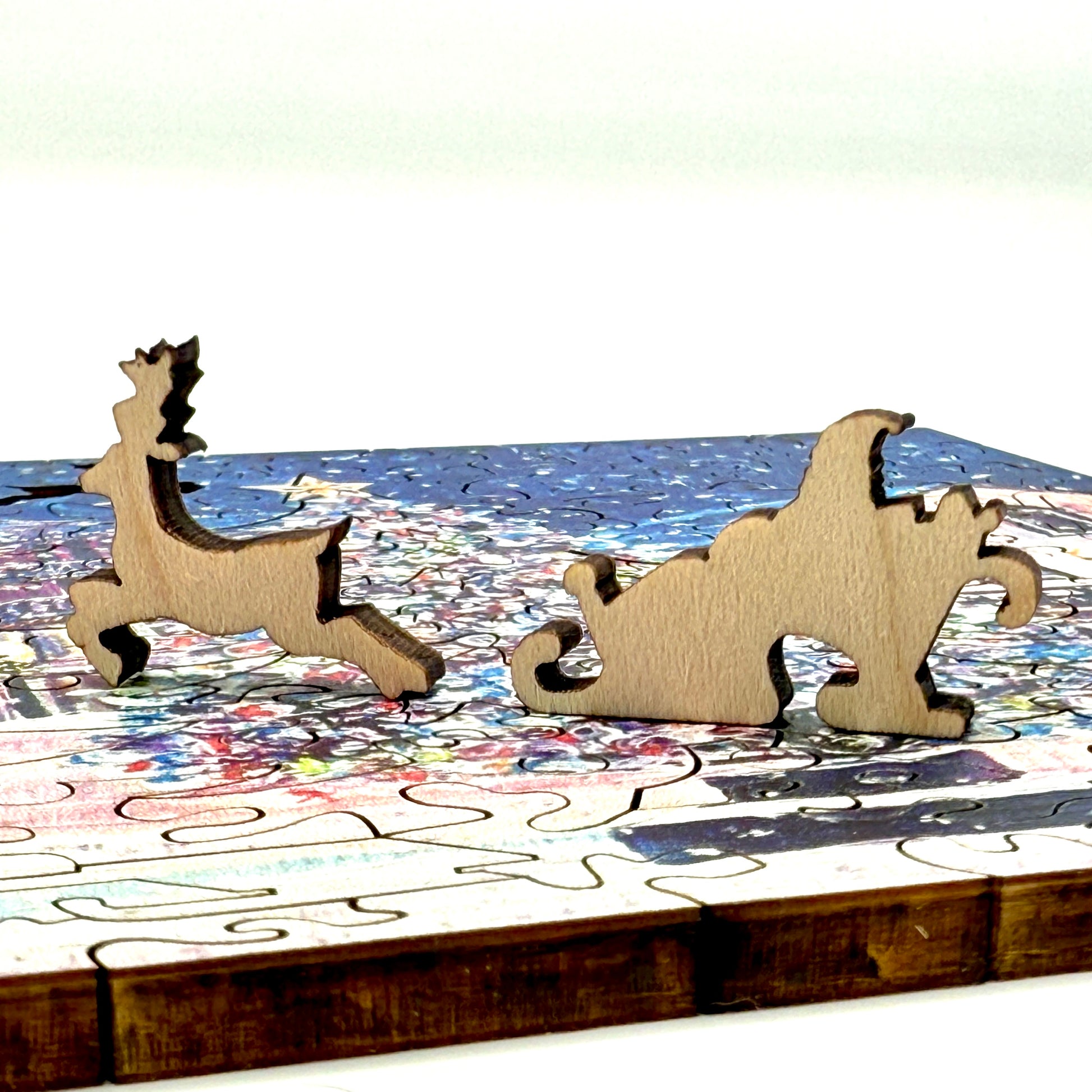 Close up of wooden whimsy pieces from the Mackinac Christmas Tree wooden Christmas puzzle.