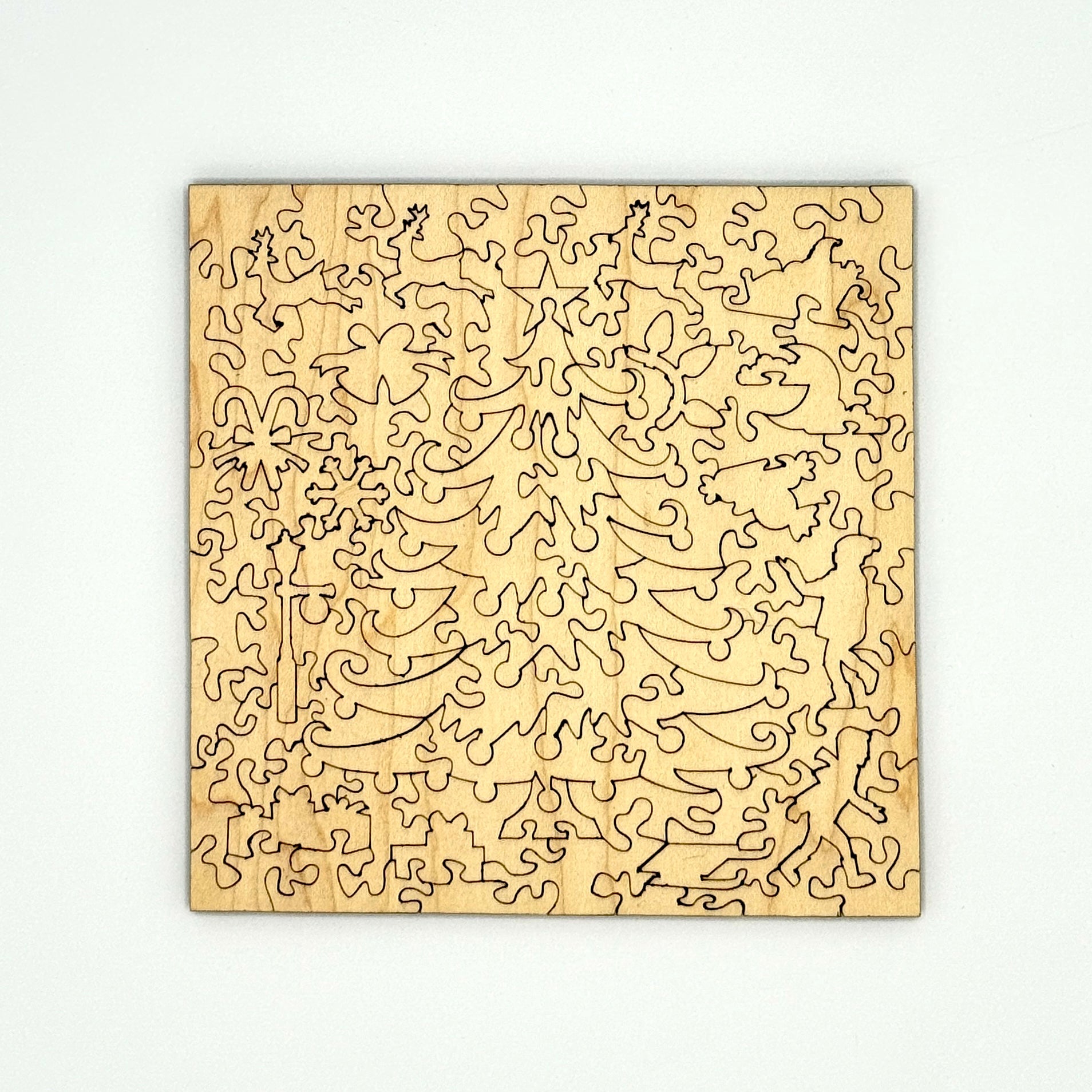 Back view of the Mackinac Christmas Tree puzzle pieces showing precision cut wooden shapes.