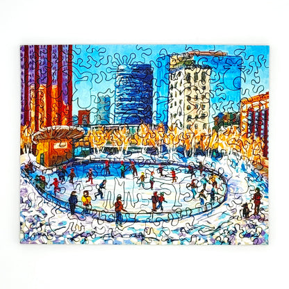 Completed Downtown Ice Skating winter scene puzzle showing skaters in a snowy city rink.