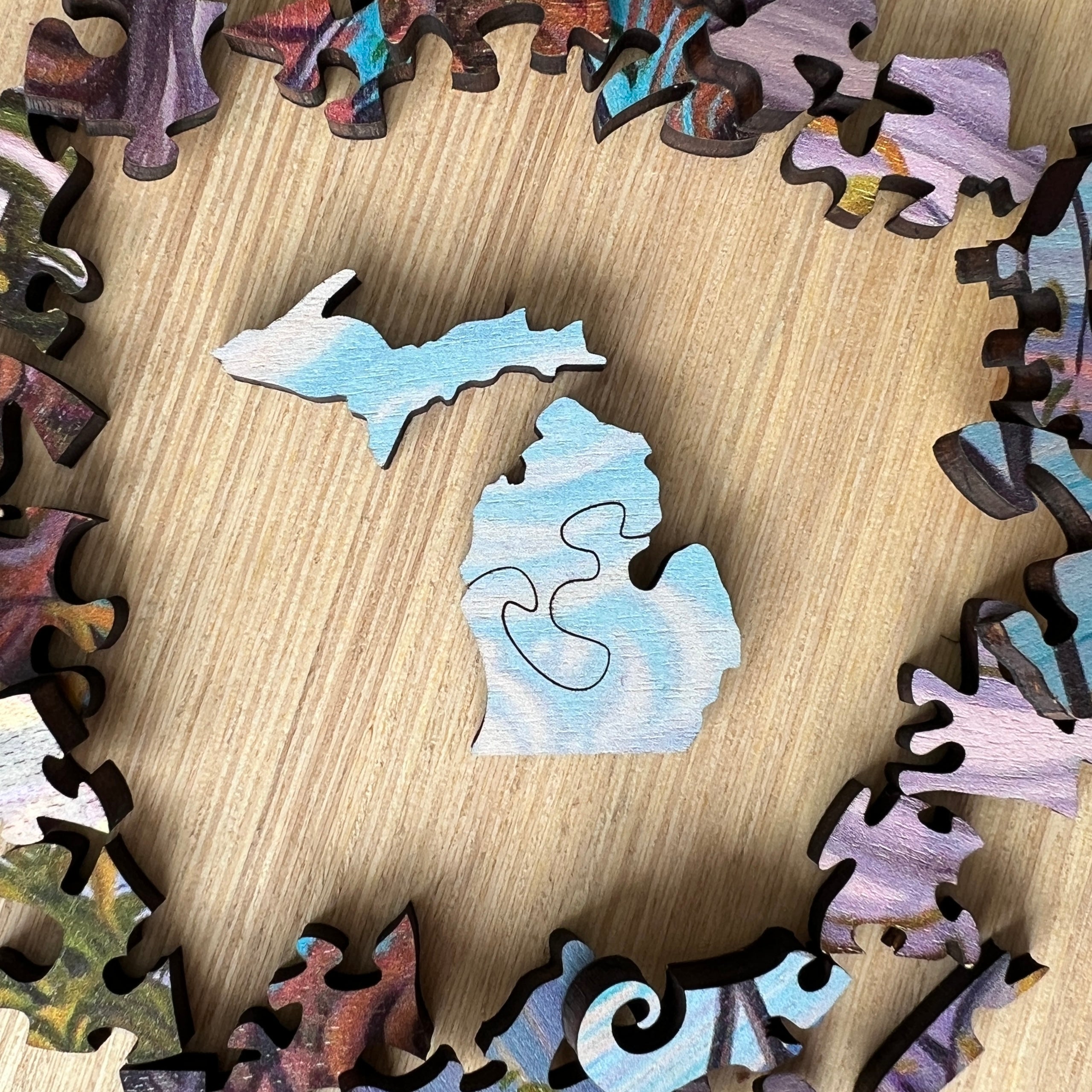 Two wooden jigsaw puzzle whimsies forming the shape of the state of Michigan.